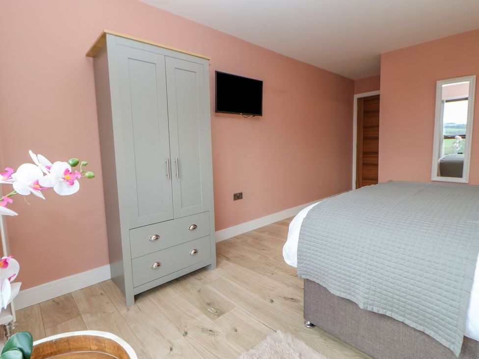 A bedroom with a wardrobe and television at Stackyard Durham