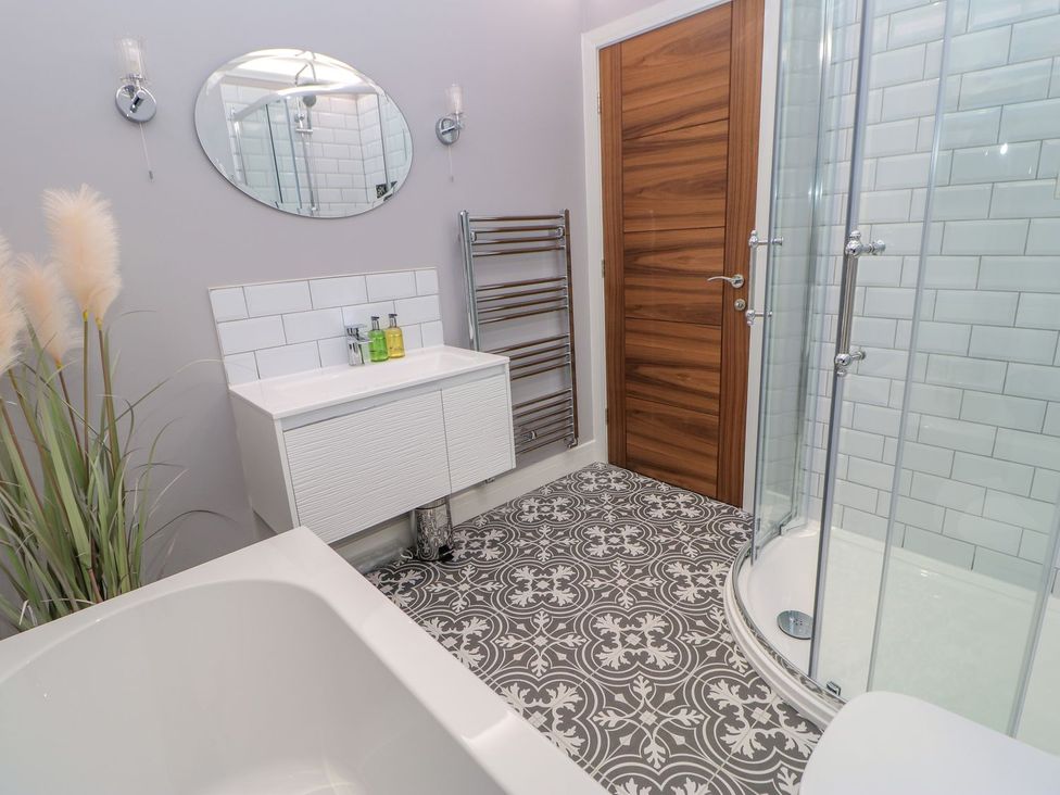 A bathroom with a bathtub and shower at Stackyard in Durham