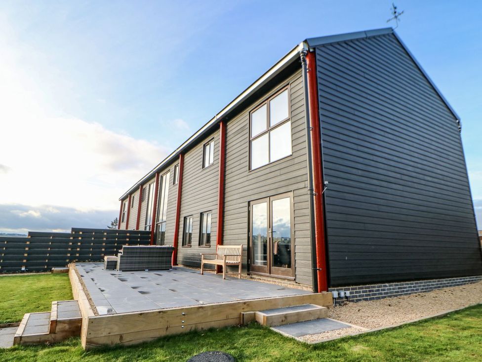 An outdoor view of a modern building with a deck at Stackyard in Durham