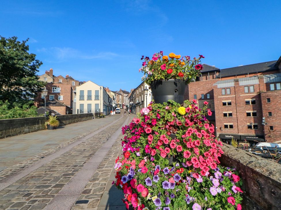 A street view with flowers and buildings at Stackyard in Durham