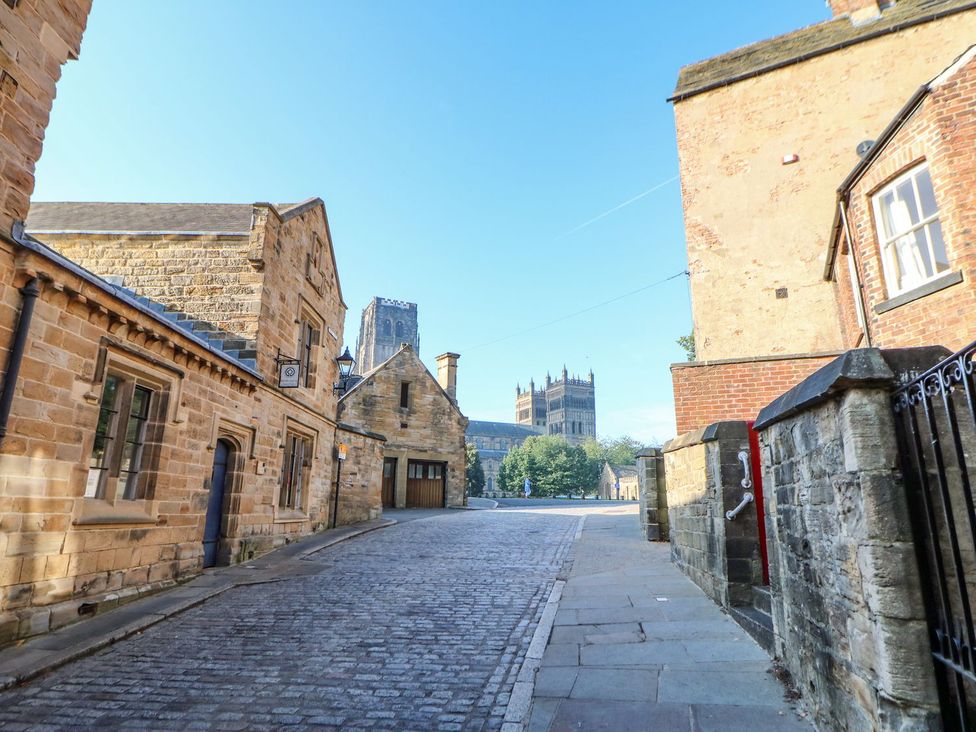 A street view with historic buildings and a cathedral in Durham