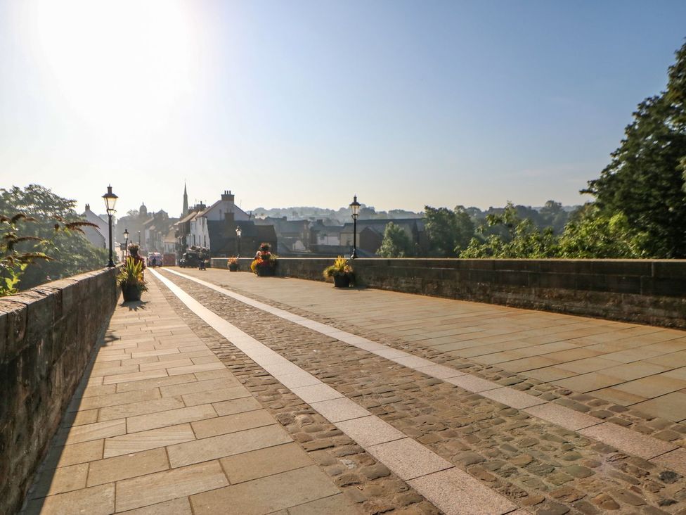 A bridge with cobblestones and street lamps at Stackyard in Durham