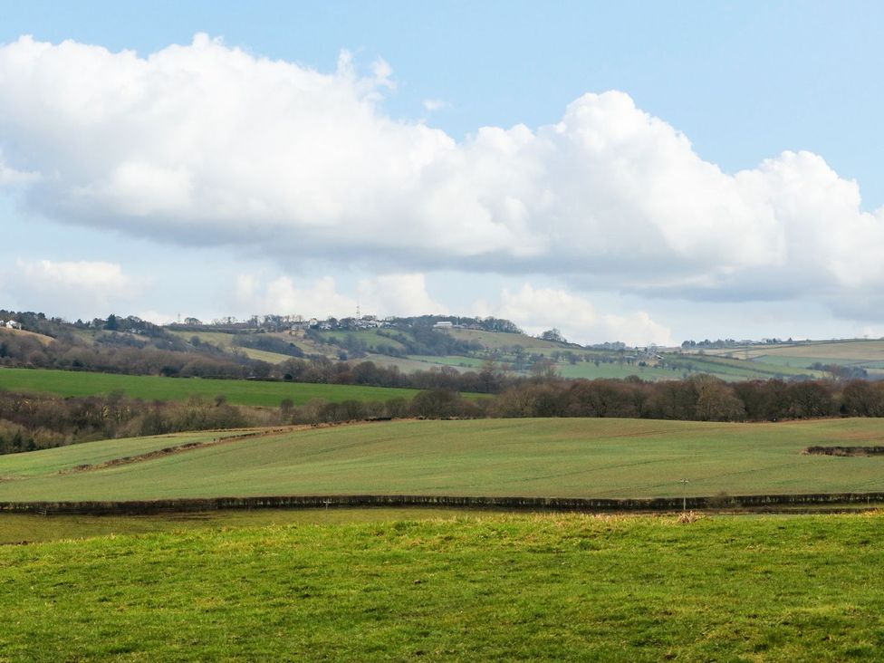 A landscape with fields and hills under a cloudy sky at Stackyard in Durham