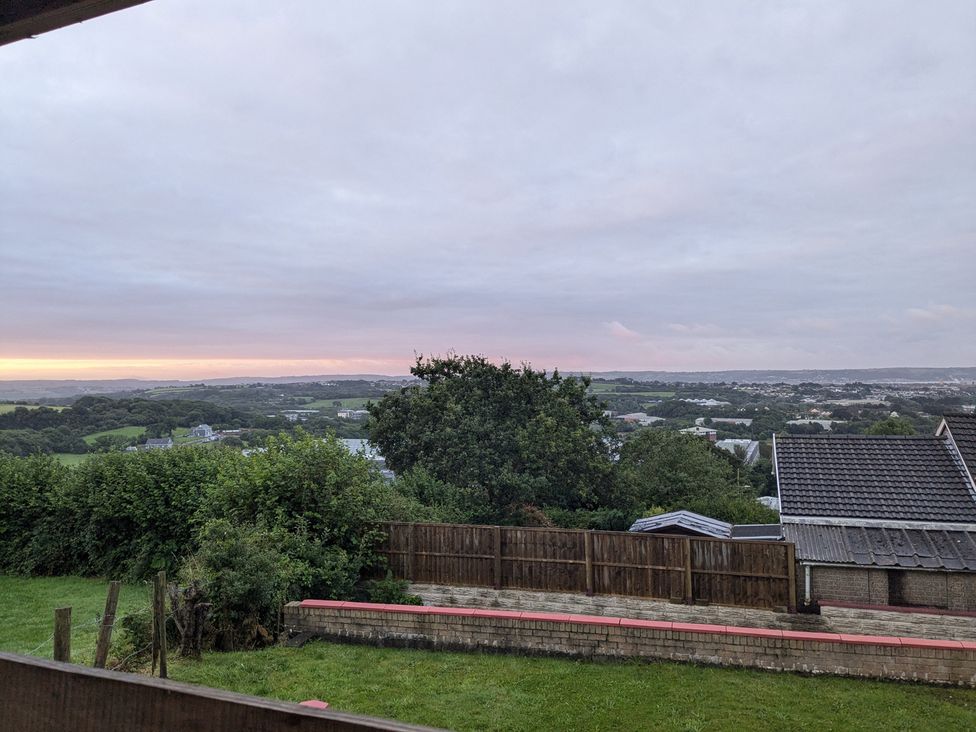 A view of the landscape and sky at The Retreat Cabin in Llanelli