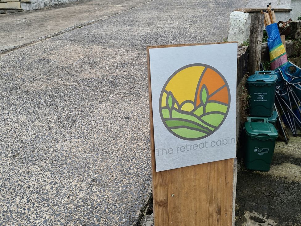 A sign for The Retreat Cabin outdoors in Llanelli