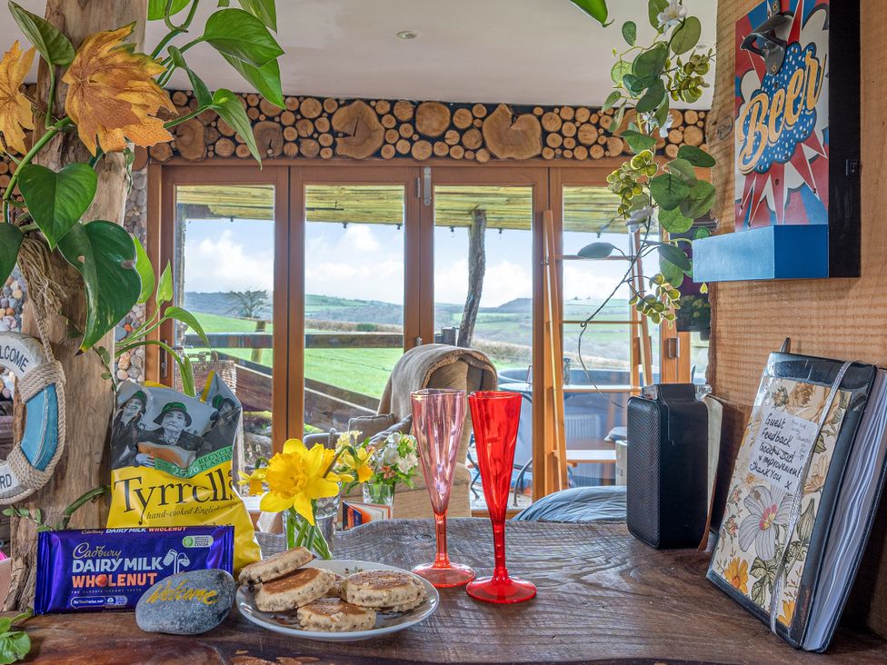 A table with food and drinks at The Retreat Cabin in Llanelli