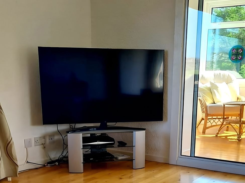 A living room with a television on a media console at Erisgeir in Isle of Mull