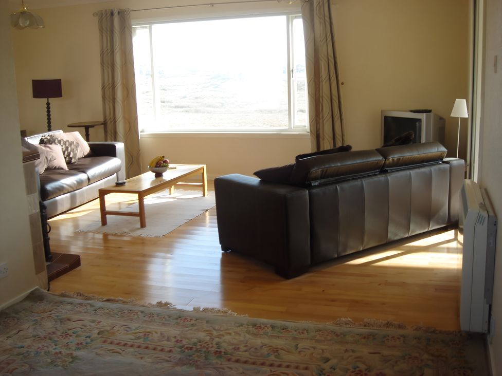 A living room with a sofa and coffee table at Erisgeir in Isle of Mull