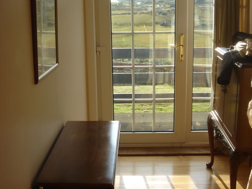 An entryway with a bench and a mirror at Erisgeir Isle of Mull