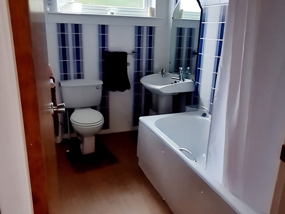 A bathroom with a toilet, sink, and bathtub at Erisgeir on Isle of Mull