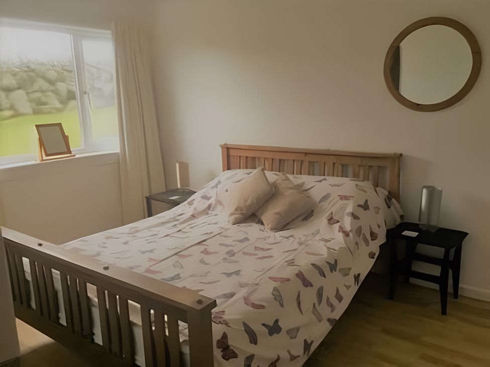 A bedroom with a bed and bedside table at Erisgeir in Isle of Mull