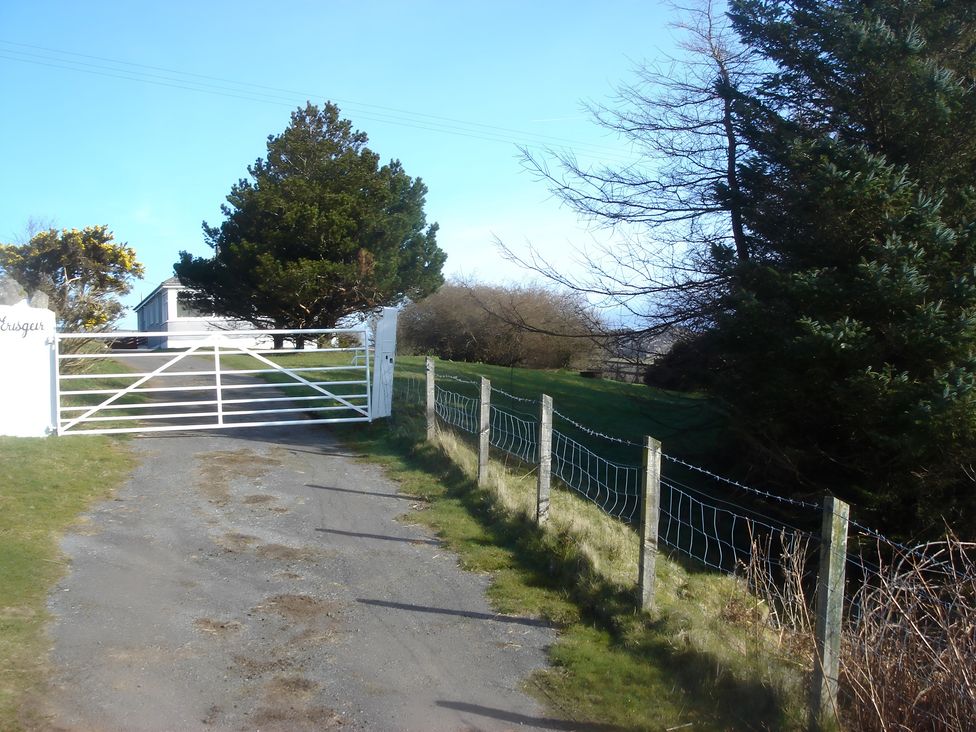 A driveway with a gate and trees at Erisgeir Isle of Mull