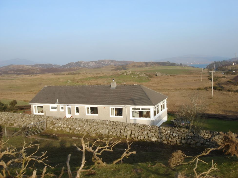 A house surrounded by stone wall and landscape at Erisgeir Isle of Mull