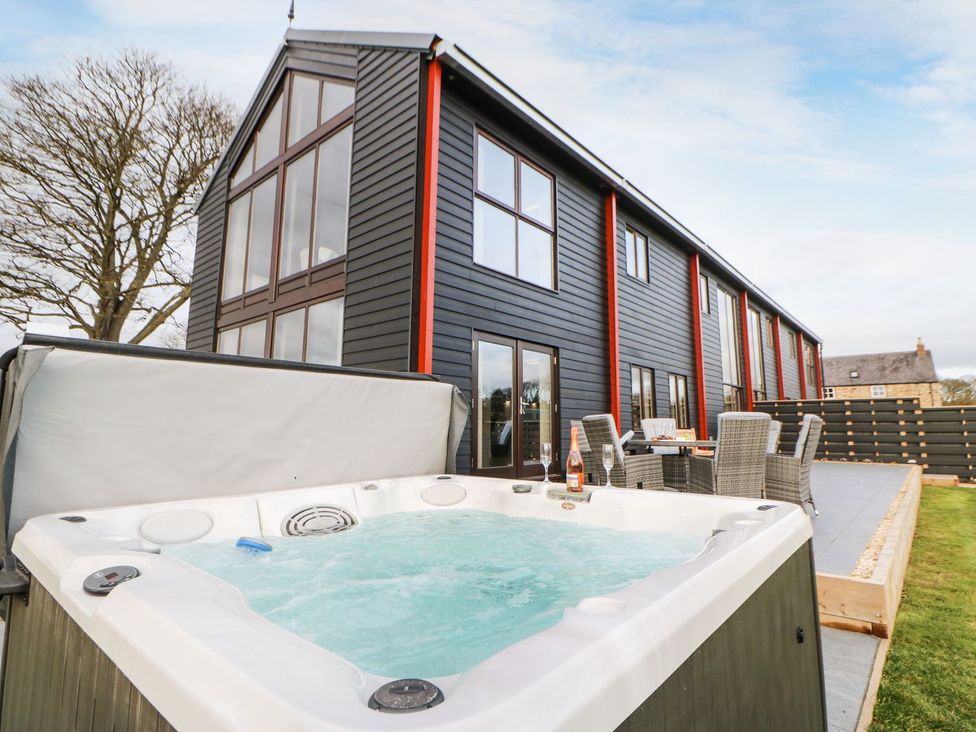 An outdoor area with a hot tub and seating at High Church Hill in Durham