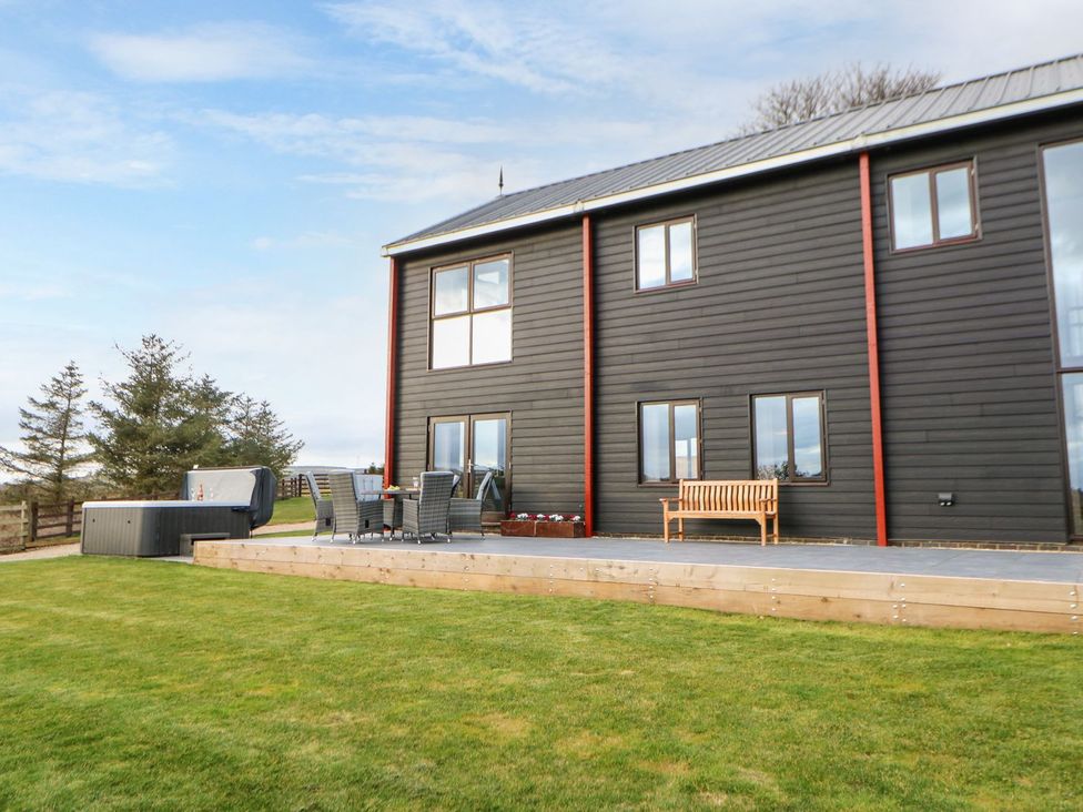 An outdoor area with a hot tub and seating at High Church Hill in Durham