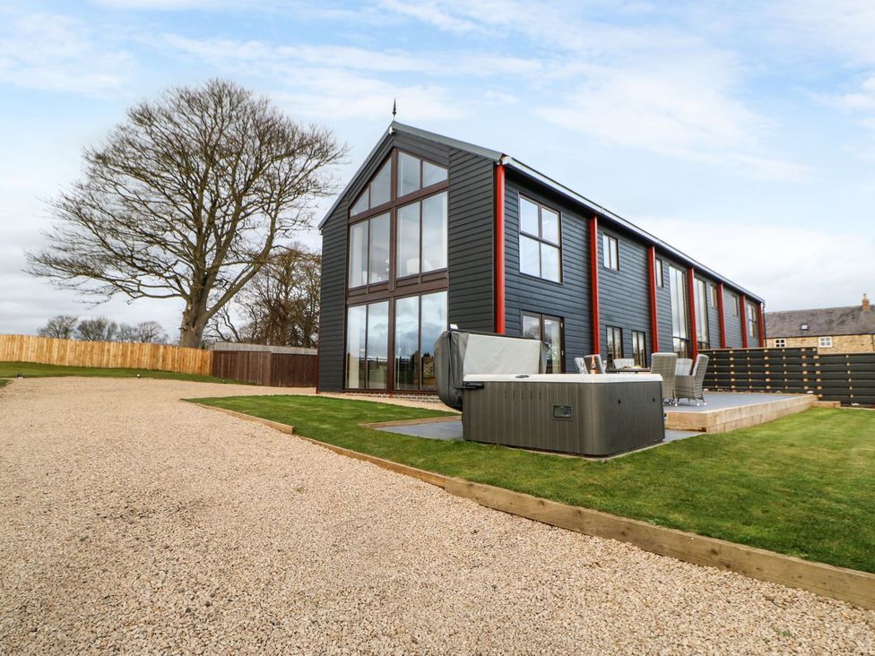 An outdoor view of a building with a hot tub at High Church Hill in Durham