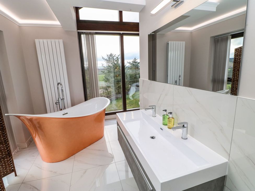 A bathroom with a bathtub and sink at High Church Hill in Durham