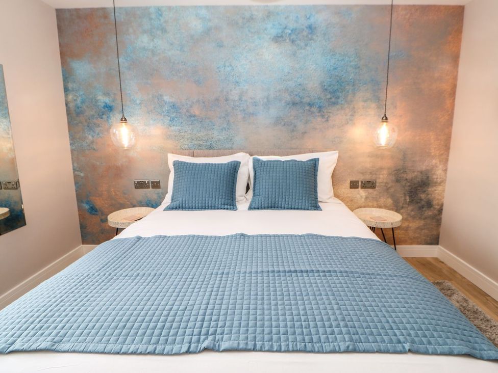 A bedroom with a bed and blue cushions at High Church Hill in Durham