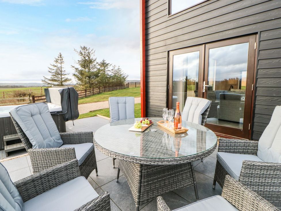 An outdoor patio with a round table and chairs at High Church Hill in Durham