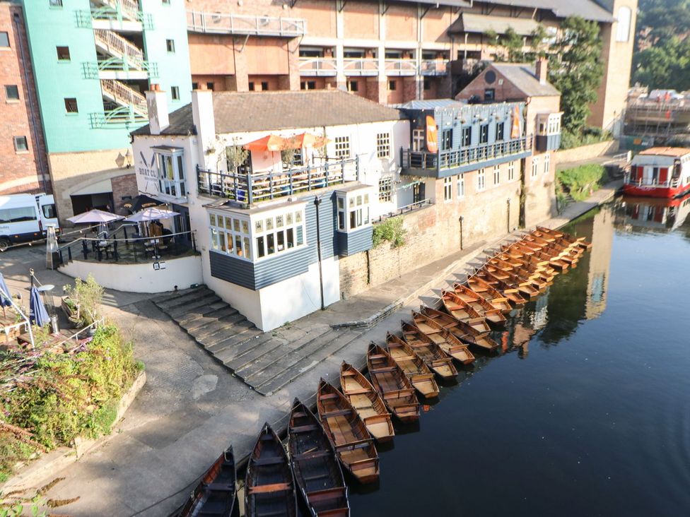 A boathouse with boats along the river at High Church Hill in Durham