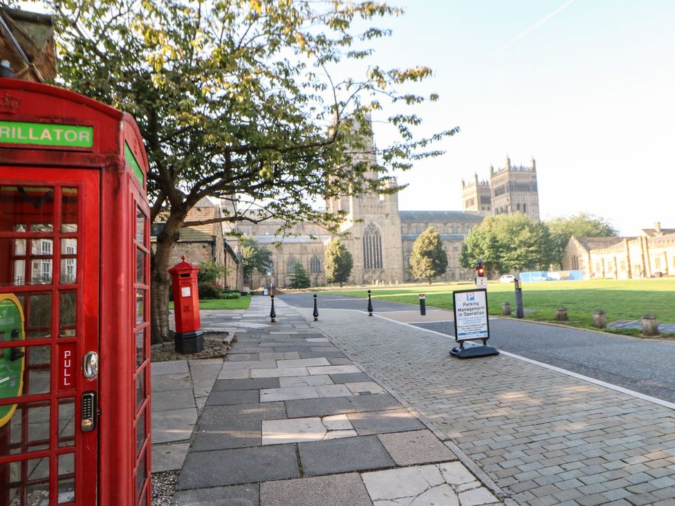 A street view with a phone booth and a post box at High Church Hill in Durham