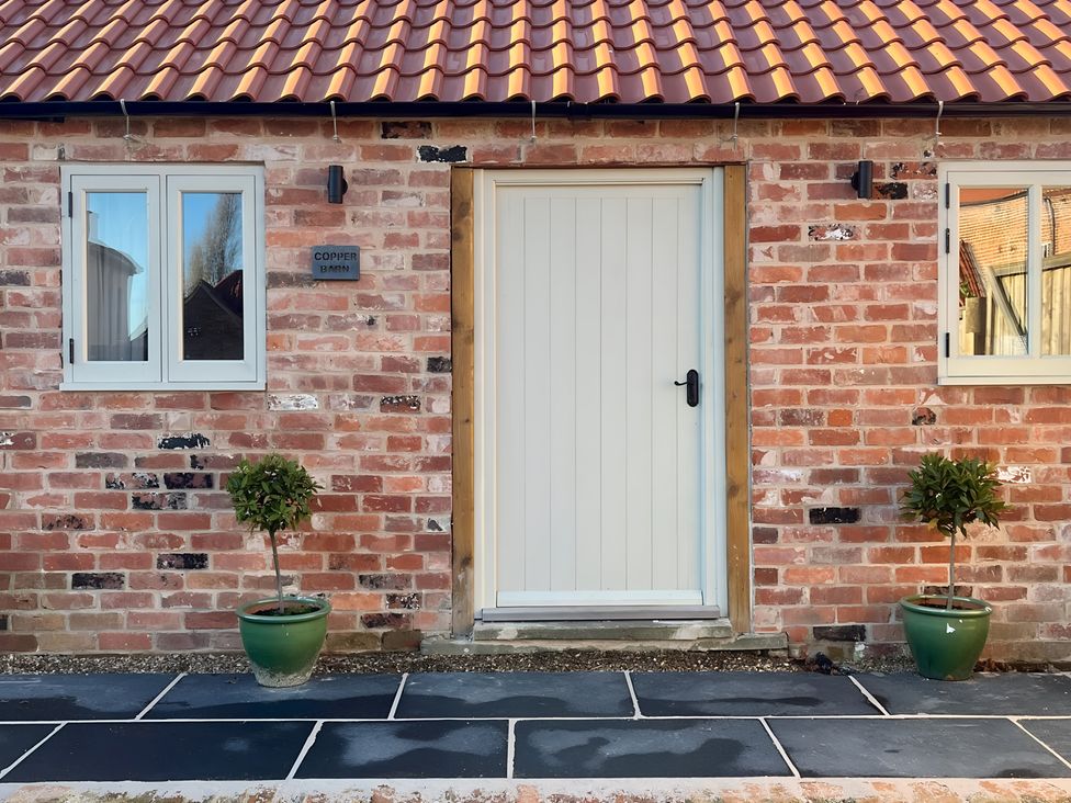 An entrance with a door and windows at Coach Lodge in Retford