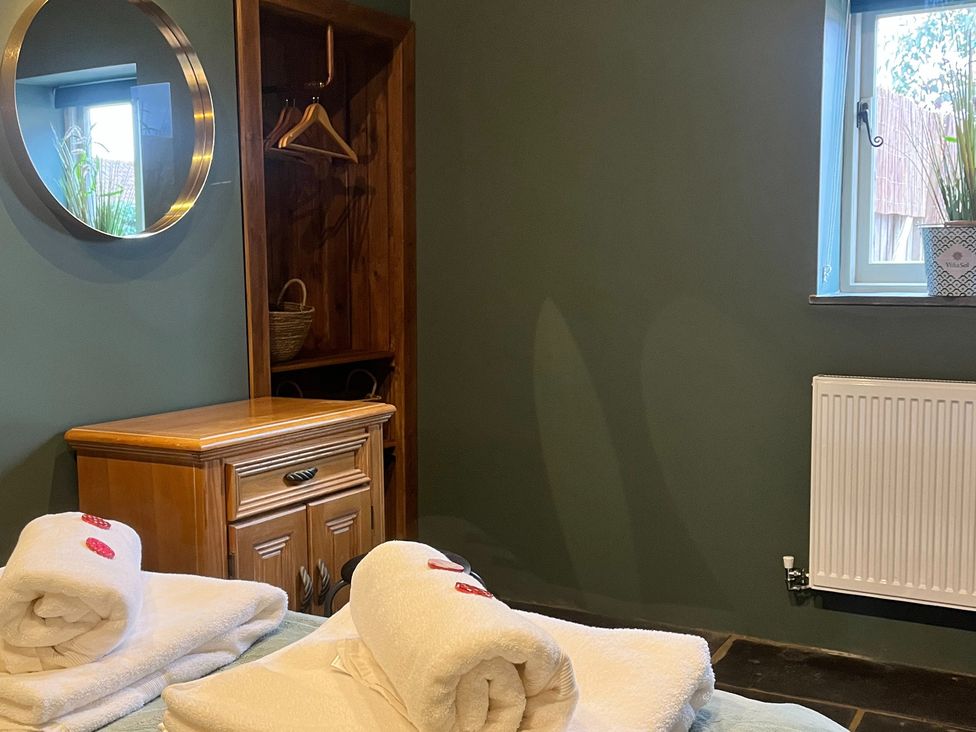 A bedroom with towels on a bed at Coach Lodge in Retford