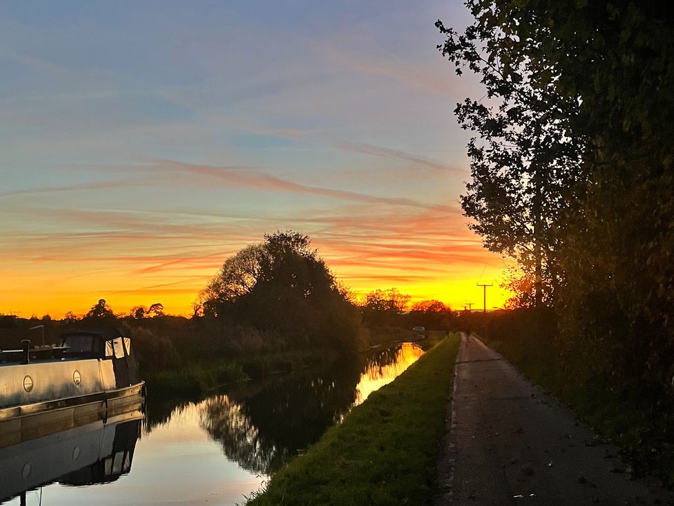 A canal with a boat at sunset at Coach Lodge in Retford