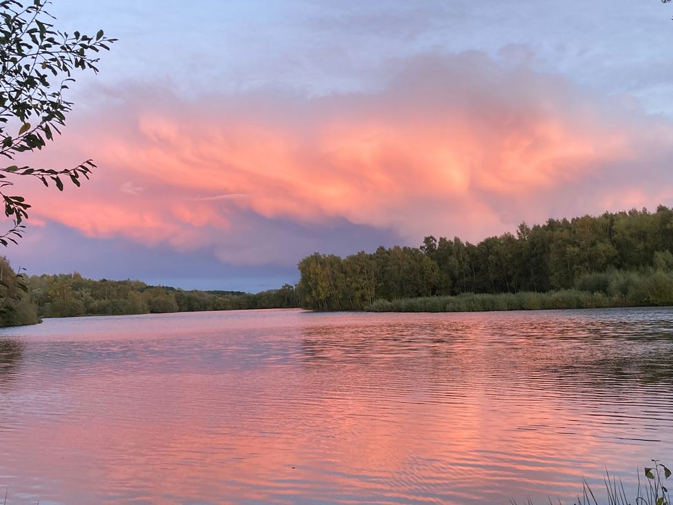 A scenic view of a river with trees and clouds at Coach Lodge, Retford