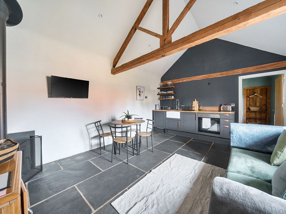 A living room with a kitchen area and dining table at Coach Lodge in Retford