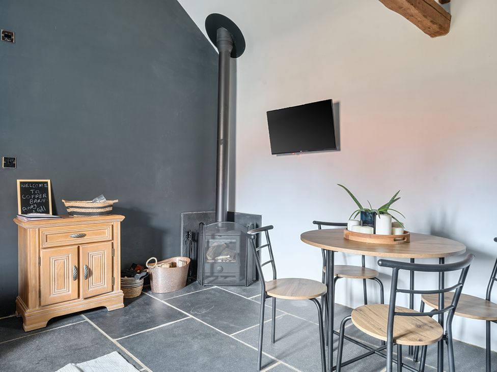 A dining room with a table and chairs at Coach Lodge in Retford