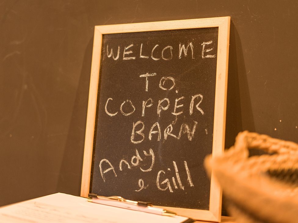 A welcome chalkboard sign at Copper Barn by Andy and Gill