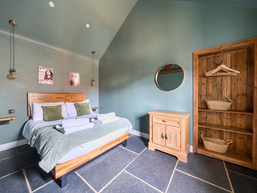 A bedroom with a bed and nightstand at Coach Lodge in Retford