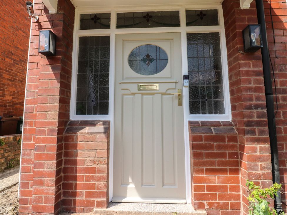 A front door with glass panels and brick wall at 11 Sandhurst Avenue Lytham St. Annes