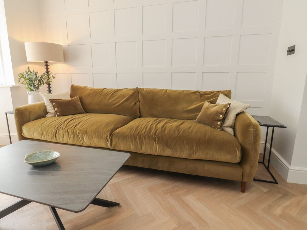 A living room with a sofa and coffee table at 11 Sandhurst Avenue in Lytham St. Annes