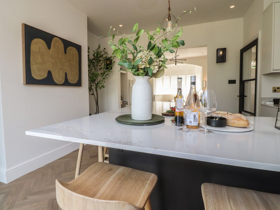 A dining room featuring a table with flowers and bottles at 11 Sandhurst Avenue Lytham St. Annes