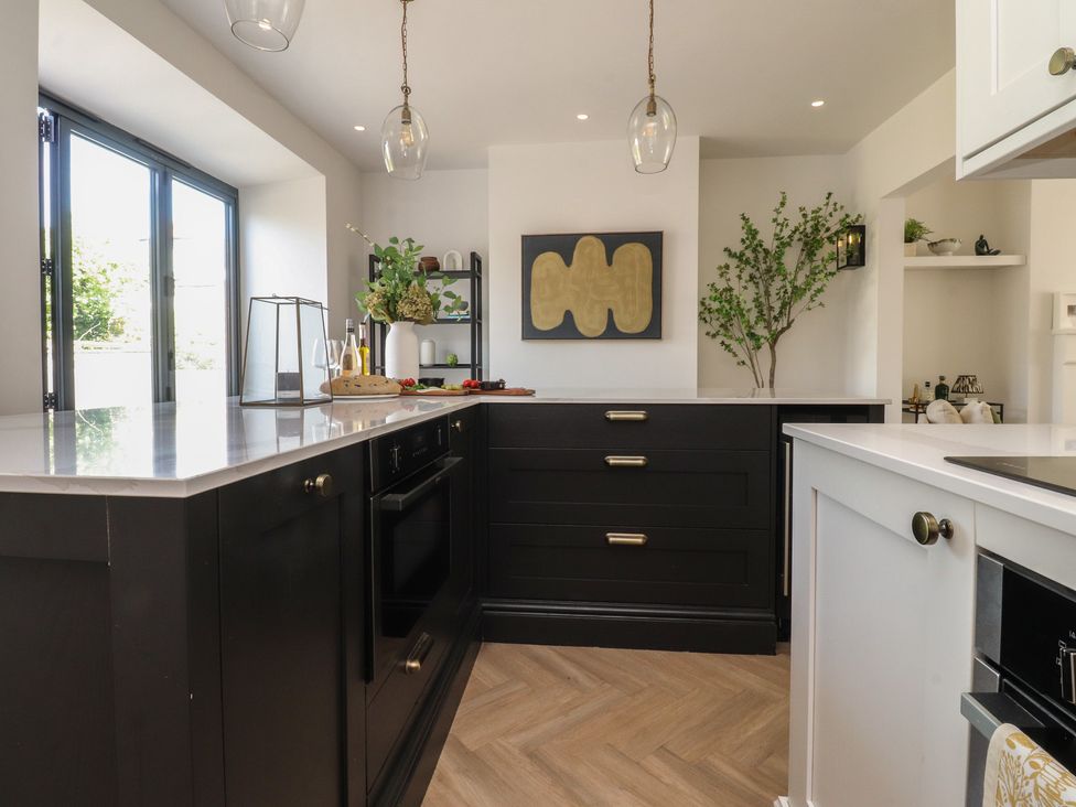 A kitchen with black cabinets and a countertop at 11 Sandhurst Avenue Lytham St. Annes