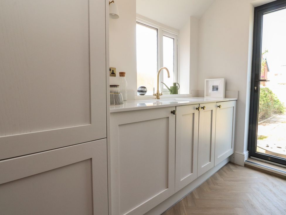 A kitchen with cabinets and a sink at 11 Sandhurst Avenue Lytham St. Annes