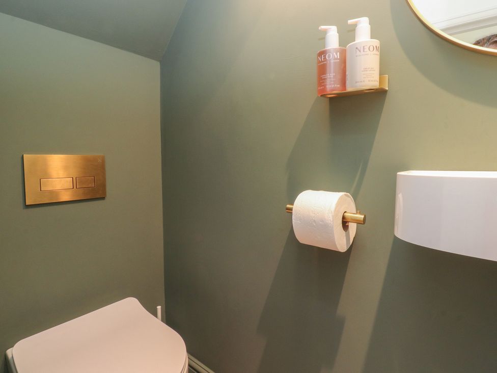 A bathroom with a toilet and soap dispensers at 11 Sandhurst Avenue, Lytham St. Annes