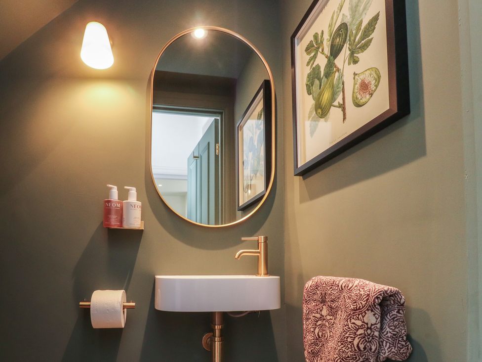 A bathroom with a sink and mirror at 11 Sandhurst Avenue in Lytham St. Annes