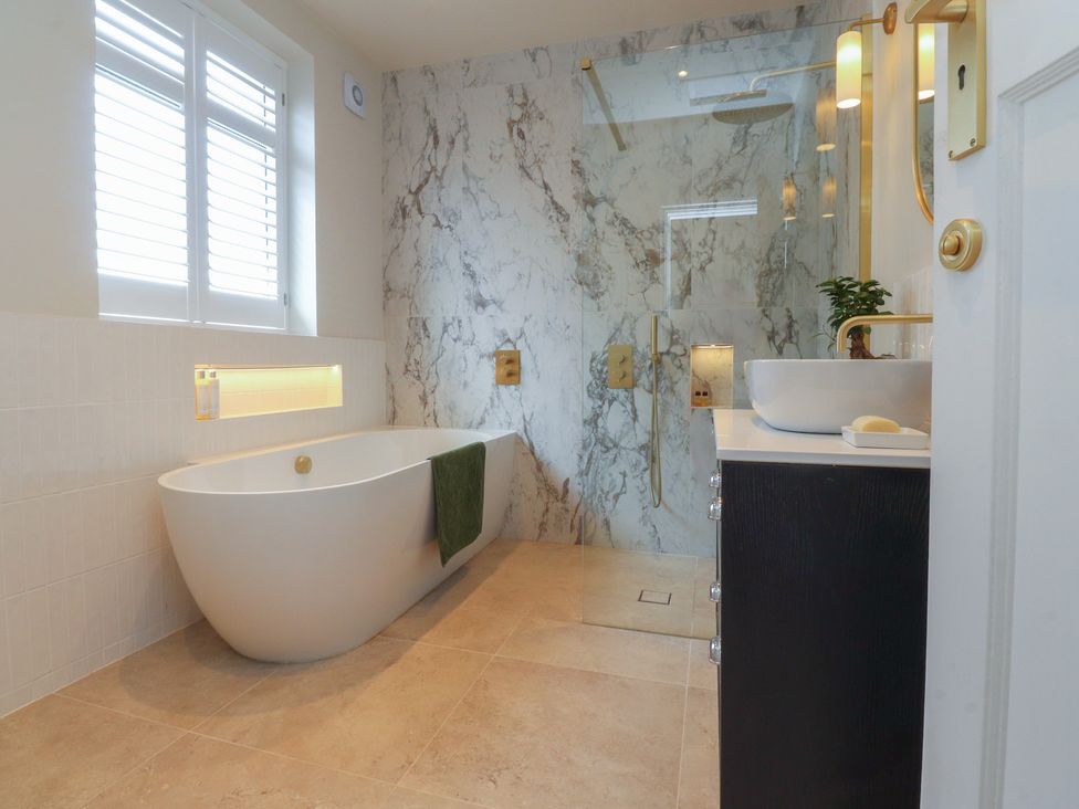 A bathroom with a bathtub and shower at 11 Sandhurst Avenue in Lytham St. Annes