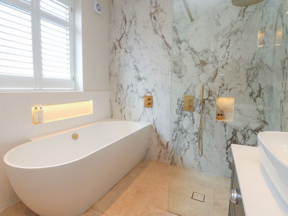 A bathroom with a bathtub and shower at 11 Sandhurst Avenue Lytham St. Annes