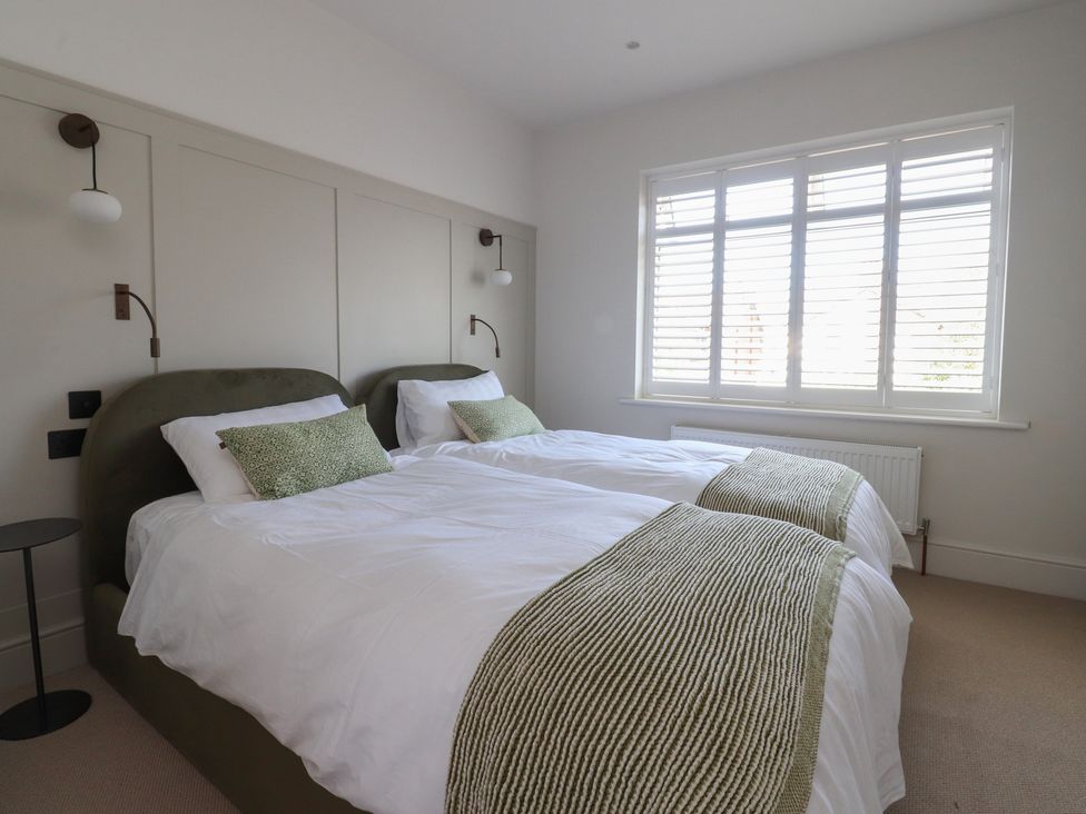 A bedroom with two beds and a window at 11 Sandhurst Avenue Lytham St. Annes