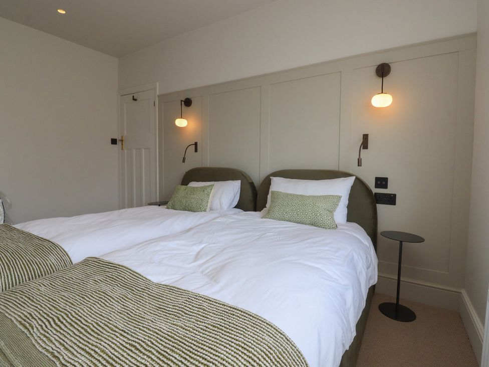 A bedroom with twin beds and a bedside table at 11 Sandhurst Avenue in Lytham St. Annes