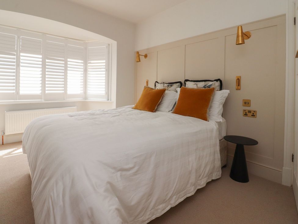 A bedroom with a bed and bedside table at 11 Sandhurst Avenue Lytham St. Annes