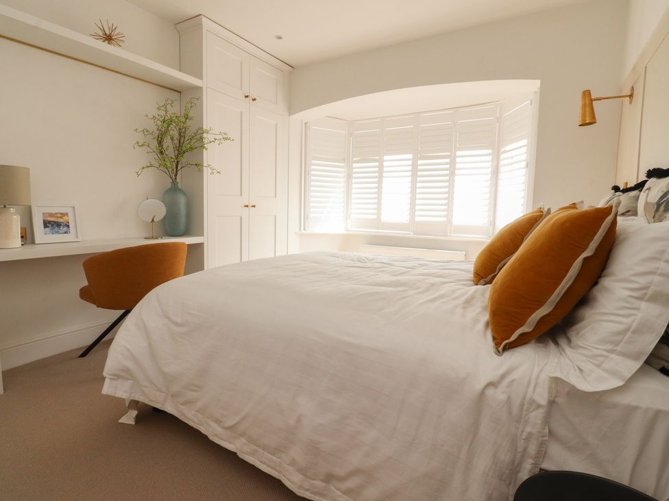 A bedroom with a bed and desk at 11 Sandhurst Avenue Lytham St. Annes