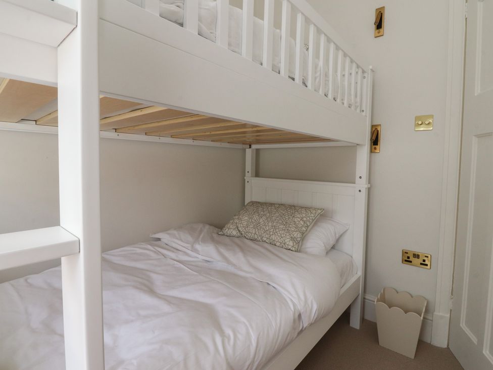 A bunk bed with bedding in a bedroom at 11 Sandhurst Avenue Lytham St. Annes