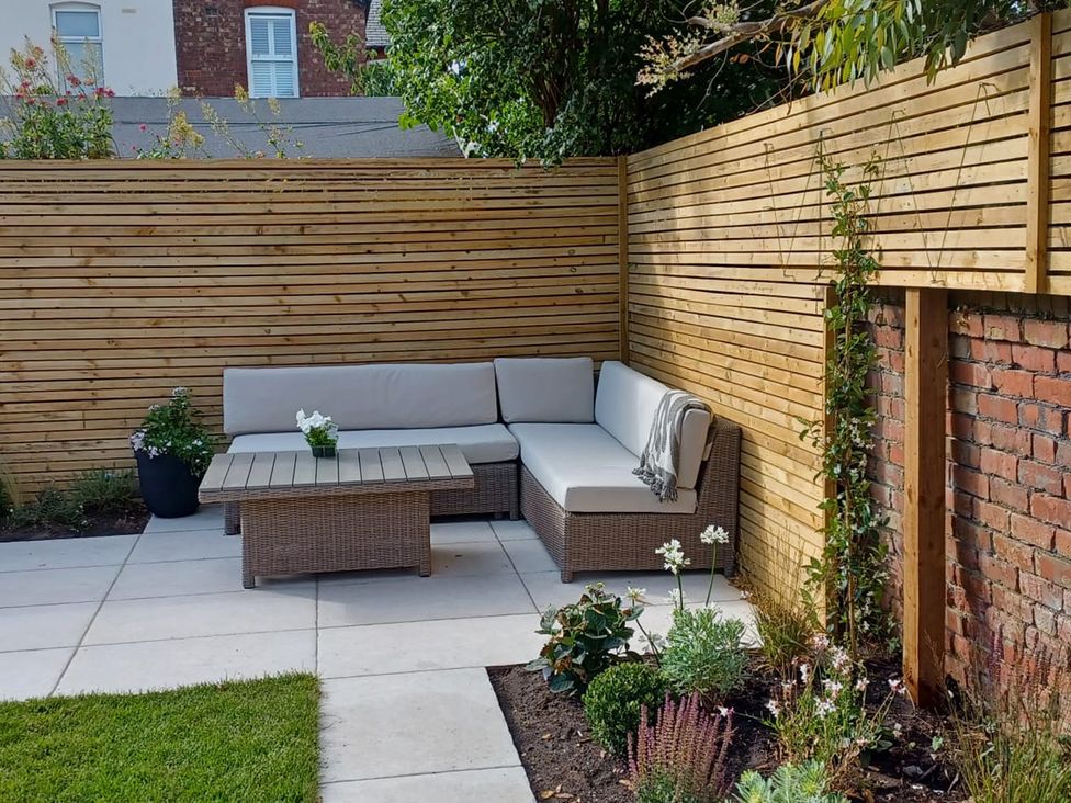 A garden area with a sofa and coffee table at 11 Sandhurst Avenue Lytham St. Annes