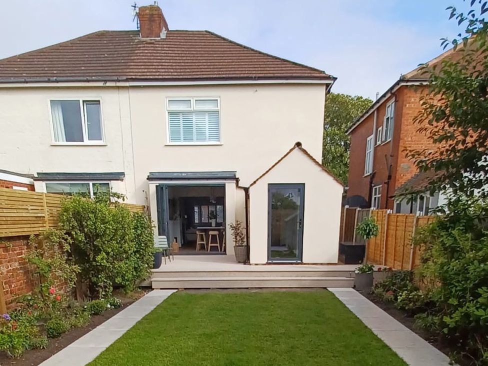 A garden with a house and patio area at 11 Sandhurst Avenue Lytham St. Annes