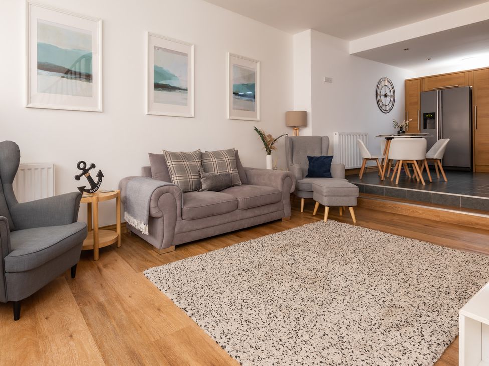 A living room with a sofa and armchair at 11A Cards Wynd in Anstruther